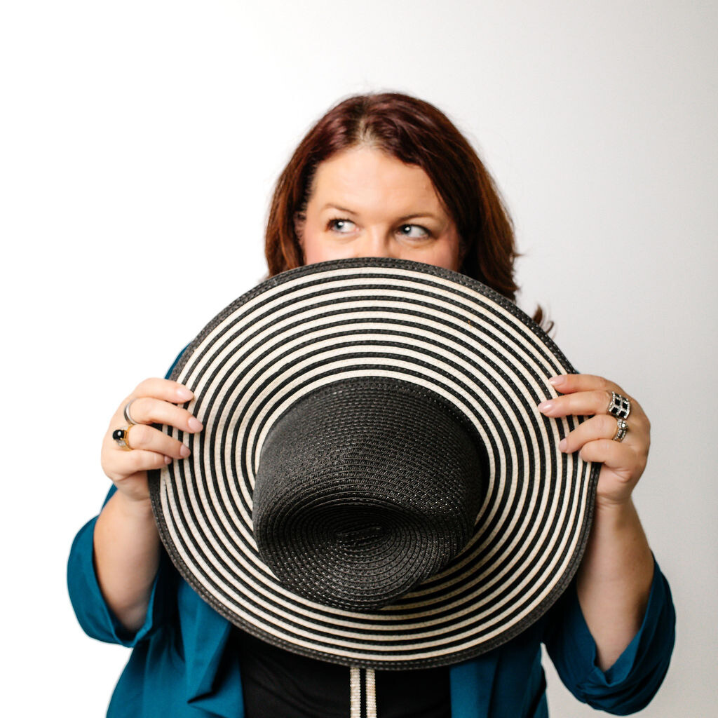 Nikole Haumont looking over a hat